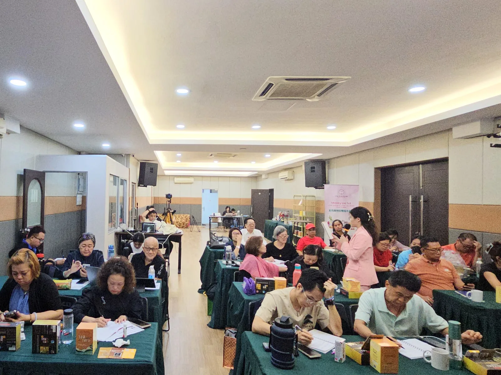 DCK trainer moving through a busy practical workshop in Klang