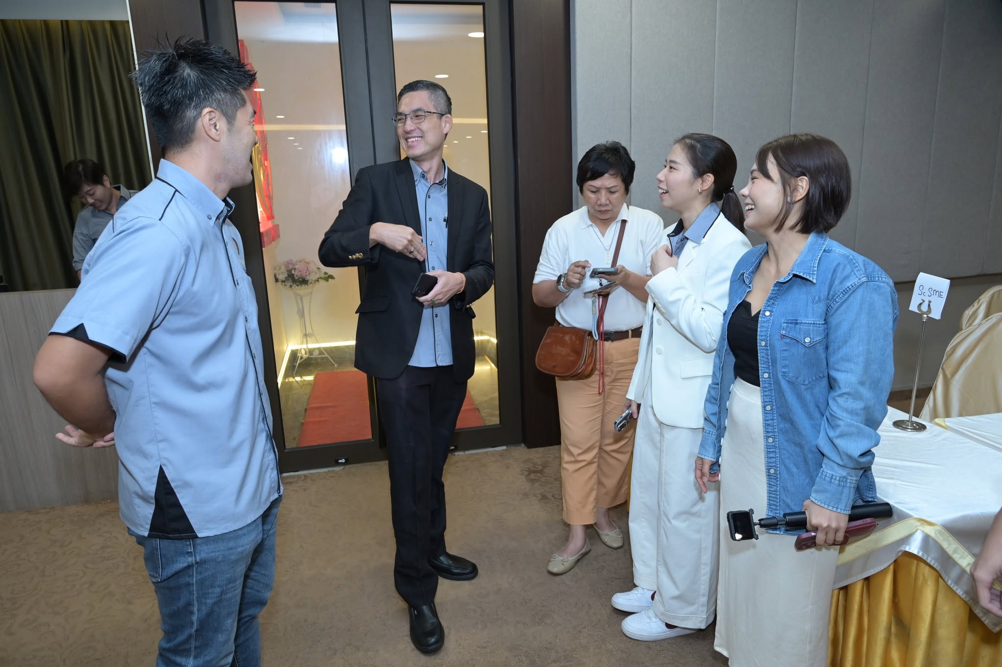 Members sharing a light conversation at event arrival