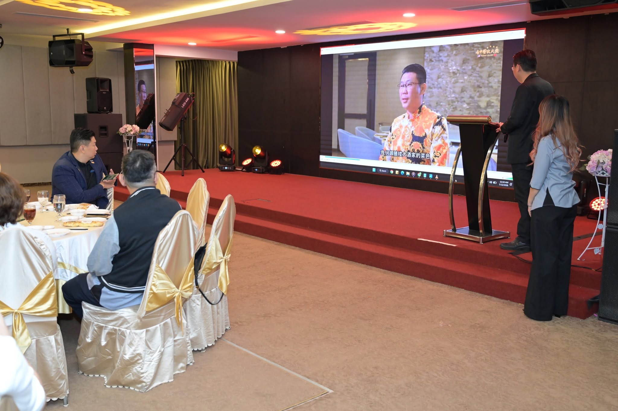 Members watching a business video during an event